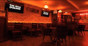 Pub seating area with brick-wall wall lights, commercial fit-out by Fox Electrical